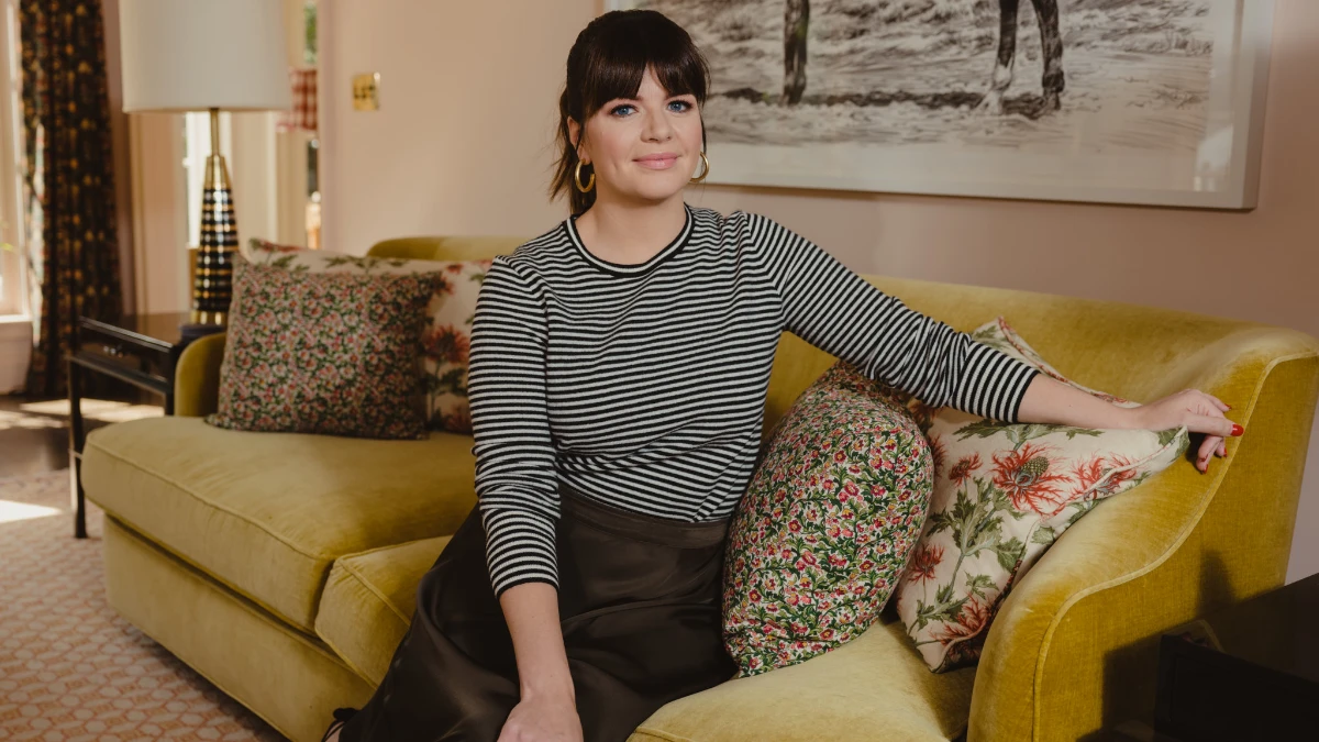 Casey Wilson smiling in a Hollywood photoshoot, celebrating her birthday and career achievements, with text overlay in Hindi and English