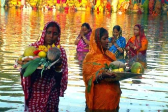 छठ पूजा उषा अर्घ्य का चित्र: सूर्य देव को प्रातःकालीन अर्घ्य देते हुए भक्त, पूजा सामग्री और पवित्र नदी तट का दृश्य | Image of Chhath Puja Usha Arghya ritual with devotees offering morning arghya to Sun God, worship items, and sacred river bank