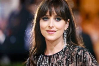 Dakota Johnson smiling in a red carpet event, with text overlay in Hindi and English about her journey from 'Fifty Shades' to Hollywood success