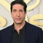 David Schwimmer as Ross Geller in Friends TV show, smiling in a coffee shop setting, with a journey map from Friends to his stardom in Bollywood style