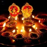 Dhanteras 2025 celebration with traditional diya, Lakshmi-Ganesh idols, and gold coins on a red cloth, symbolizing wealth and prosperity in Hindu culture.