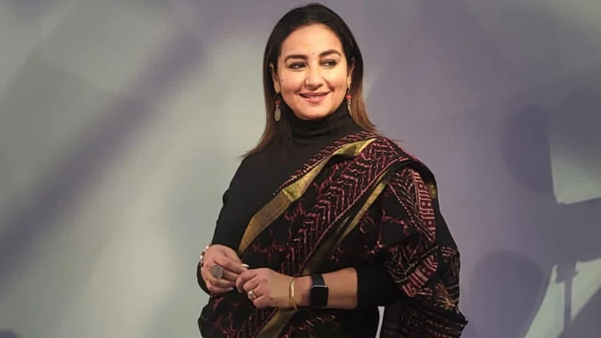 Divya Dutta smiling in a professional photoshoot, wearing traditional Indian attire, symbolizing her journey from humble beginnings to Bollywood stardom