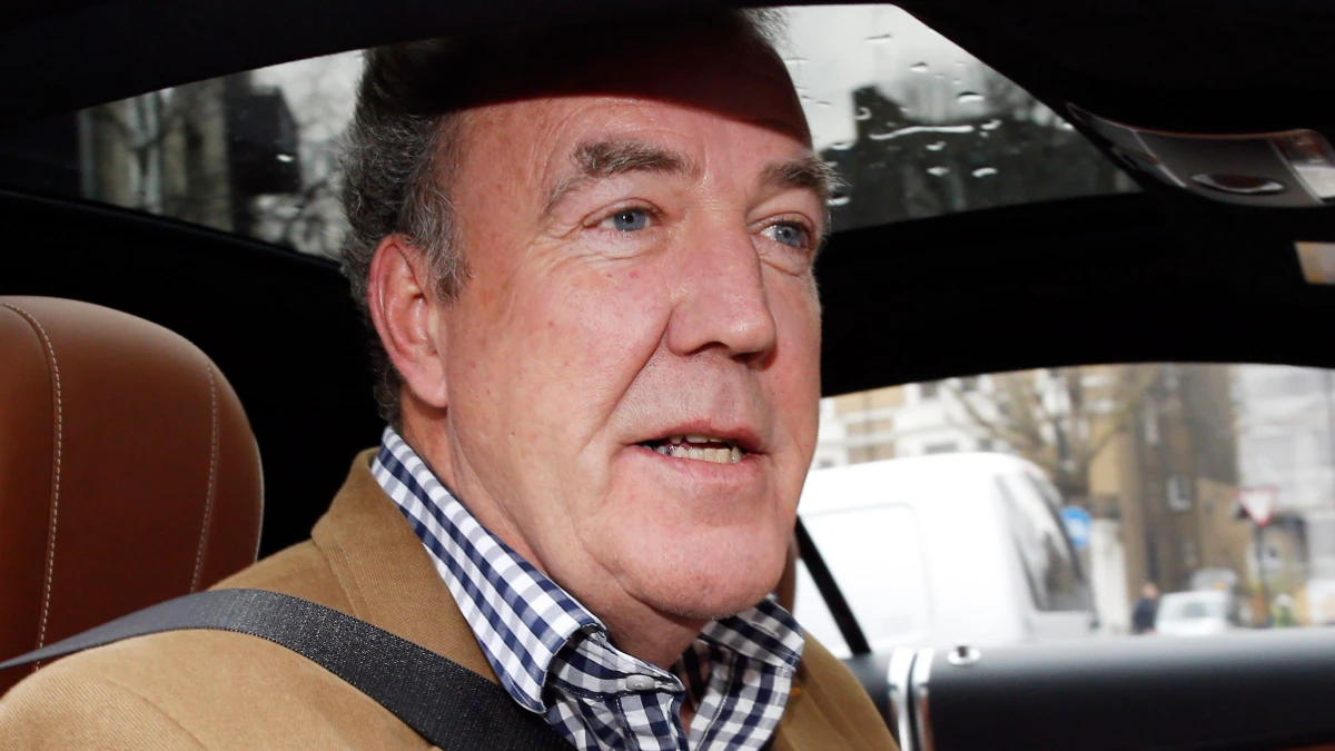 Jeremy Clarkson smiling in a car, celebrating his birthday with fans and co-hosts Richard Hammond and James May on The Grand Tour set, जेरेमी क्लार्कसन की जन्मदिन विशेष तस्वीर