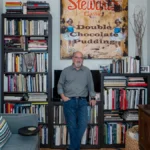 Jerry Siegel, Superman creator, black and white portrait with comic book background, biography details in Hindi and English