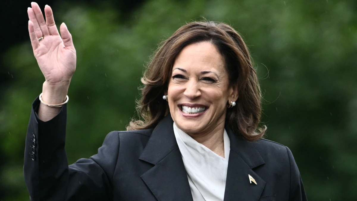 Kamala Harris smiling confidently in a professional setting, with Indian and American flags in background, representing her inspirational journey from California to Vice President