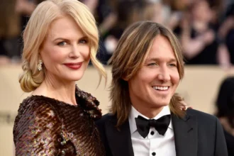 Keith Urban smiling with guitar on stage during a live performance, celebrating his birthday and musical journey in Hindi and English for AajKyaHai.com readers