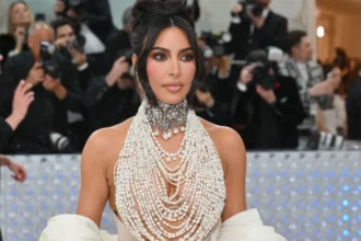 Kim Kardashian posing confidently in a business outfit, symbolizing her journey from reality TV star to a successful entrepreneur and billionaire, with text overlay in Hindi and English highlighting her empire-building strategies