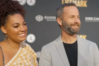 Kirk Cameron smiling in a modern photo, transitioning from his Hollywood days to his current inspirational work, with text overlay in Hindi and English