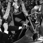 Rita Hayworth in a glamorous black and white photo pose, wearing a classic 1940s Hollywood gown with a radiant smile, symbolizing her iconic status in Bollywood and Hollywood cinema history