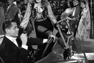 Rita Hayworth in a glamorous black and white photo pose, wearing a classic 1940s Hollywood gown with a radiant smile, symbolizing her iconic status in Bollywood and Hollywood cinema history