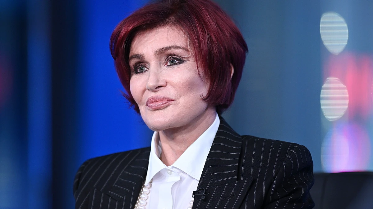 Sharon Osbourne smiling in a professional photoshoot, representing her inspiring life journey and career achievements in the entertainment industry.