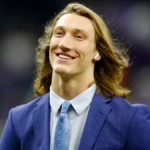 Trevor Lawrence Jacksonville Jaguars quarterback in action during NFL game, celebrating touchdown with teammates on field