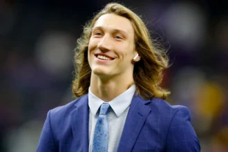Trevor Lawrence Jacksonville Jaguars quarterback in action during NFL game, celebrating touchdown with teammates on field