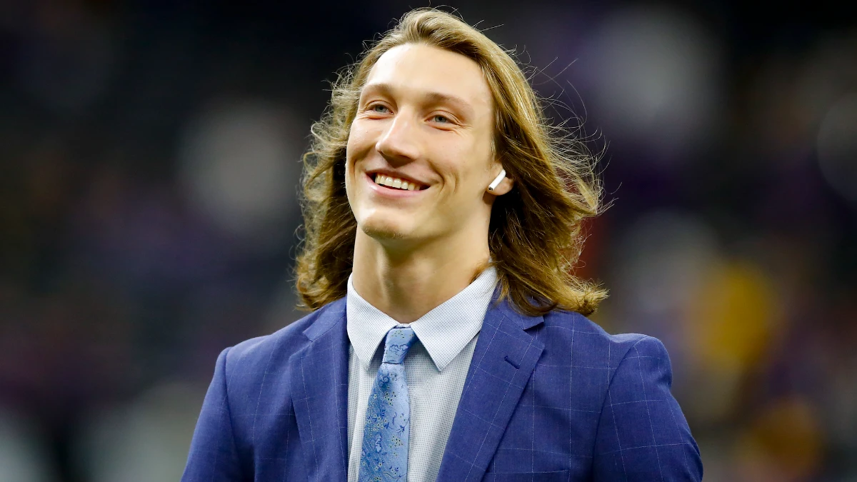 Trevor Lawrence Jacksonville Jaguars quarterback in action during NFL game, celebrating touchdown with teammates on field