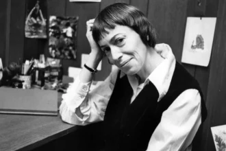 Ursula Le Guin, the Science Fiction Queen, posing thoughtfully with books in background, on AajKyaHai.com for Hindi readers