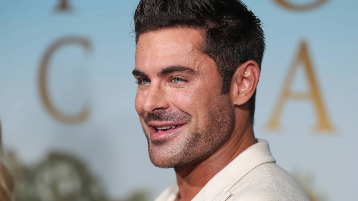 Zac Efron की सफलता की कहानी 1 Zac Efron smiling in a professional photoshoot, from his High School Musical days to current Hollywood roles, showing his career evolution in Bollywood style